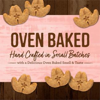 Oven Baked Cowboy Cookout leaf-shaped dog treats on a pink background that says “Oven baked hand crafted in small batches with a delicious oven baked smell &amp; taste.” 