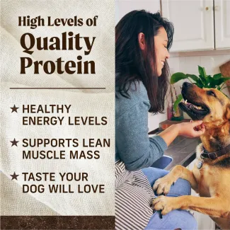 On the righthand side, a woman sits in a kitchen scratching the chin of a tan and black dog. On the lefthand side, text reads "High levels of quality proteins. Healthy energy levels, supports lean muscle mass, taste your dog will love."