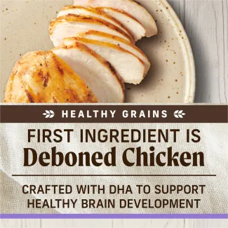 A topdown photo of cooked sliced chicken on a speckled tan plate; text below reads "healthy grains. First ingredient is deboned chicken. Crafted with DHA to support healthy brain development" 