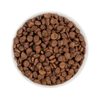 Merrick Kitchen Comforts Small Breed Real Chicken and Brown Rice Recipe kibble in a white bowl.