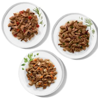 Bowls of three Merrick grilled wet cat food recipes with morsels in sauce.